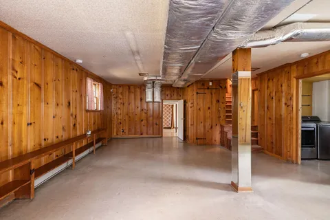 a bedroom with a bed and painting on the wall