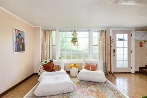 a living room with furniture and outdoor space