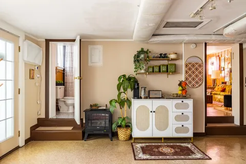 a view of a patio with chairs and a small yard