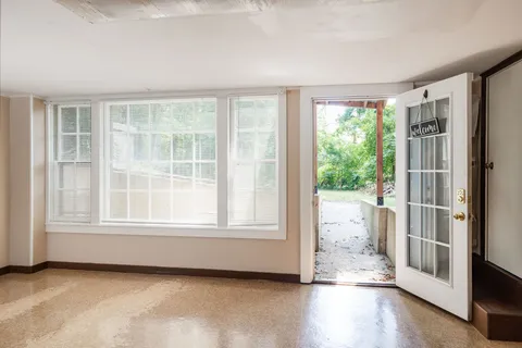 a front view of a house with a garden