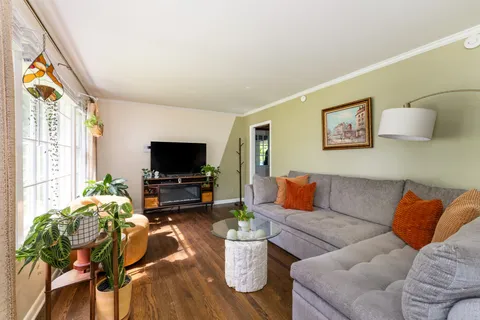 a dining table chair next to a window