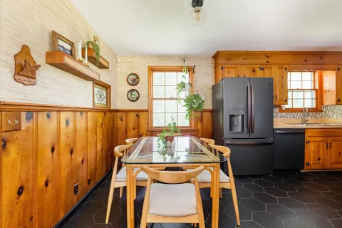 a view of a dining room with furniture and window
