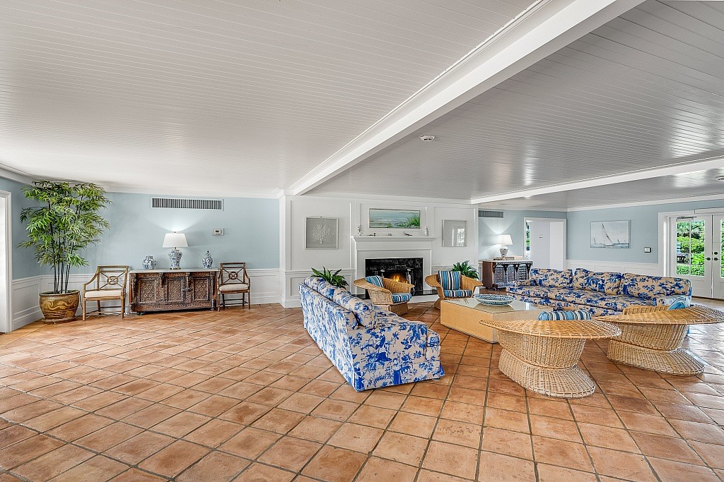 400 Beach Road, Unit 117 Vero Beach, FL 32963 - Photo 15 of 23 a living room with furniture a table and a fireplace