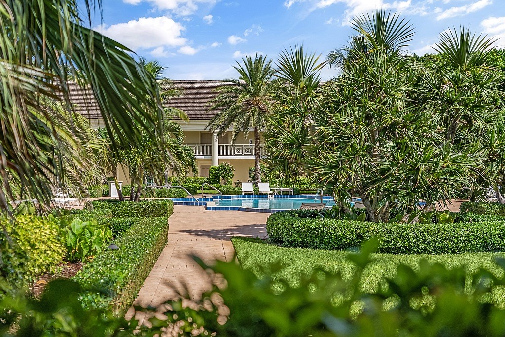 400 Beach Road, Unit 117 Vero Beach, FL 32963 - Photo 16 of 23 a view of a yard with plants and palm trees