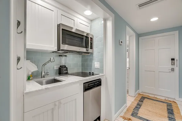 a kitchen with a sink and a stove top oven