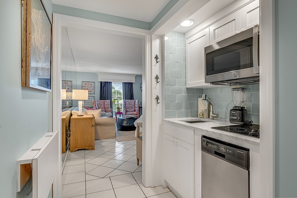 400 Beach Road, Unit 117 Vero Beach, FL 32963 - Photo 5 of 23 a kitchen with a sink and a stove top oven