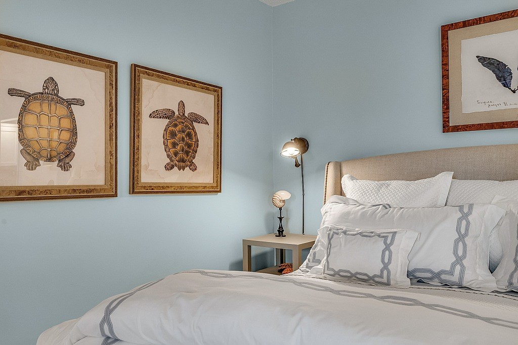 400 Beach Road, Unit 117 Vero Beach, FL 32963 - Photo 6 of 23 a bedroom with a bed and a painting on the wall
