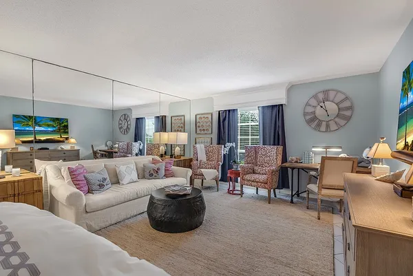 a bedroom with furniture and a flat screen tv