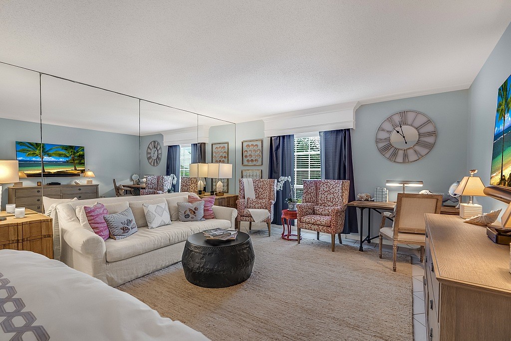 400 Beach Road, Unit 117 Vero Beach, FL 32963 - Photo 7 of 23 a living room with furniture and a large window