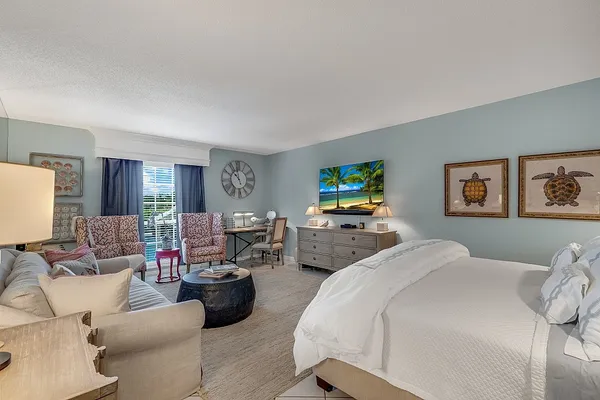 a bedroom with a bed and a flat screen tv