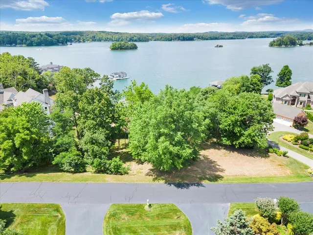 an aerial view of a houses with a lake view