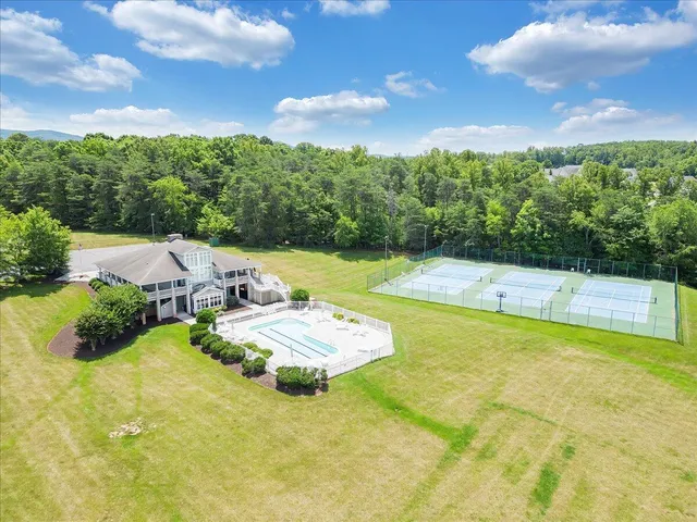 a view of an house with swimming pool and table