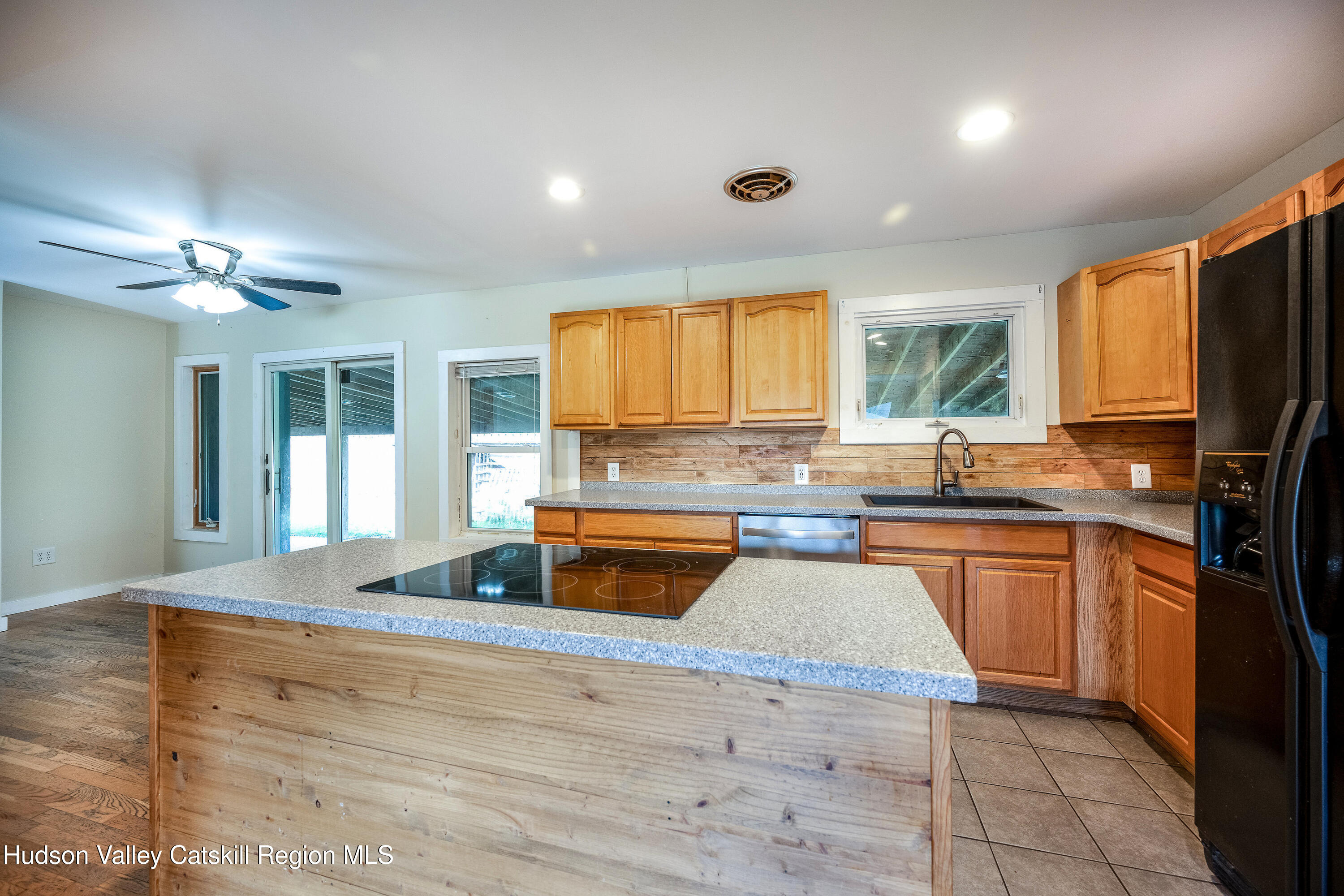 3024 Highway 213 Stone Ridge, NY 12484 - Photo 11 of 31 a kitchen with stainless steel appliances granite countertop a sink and cabinets