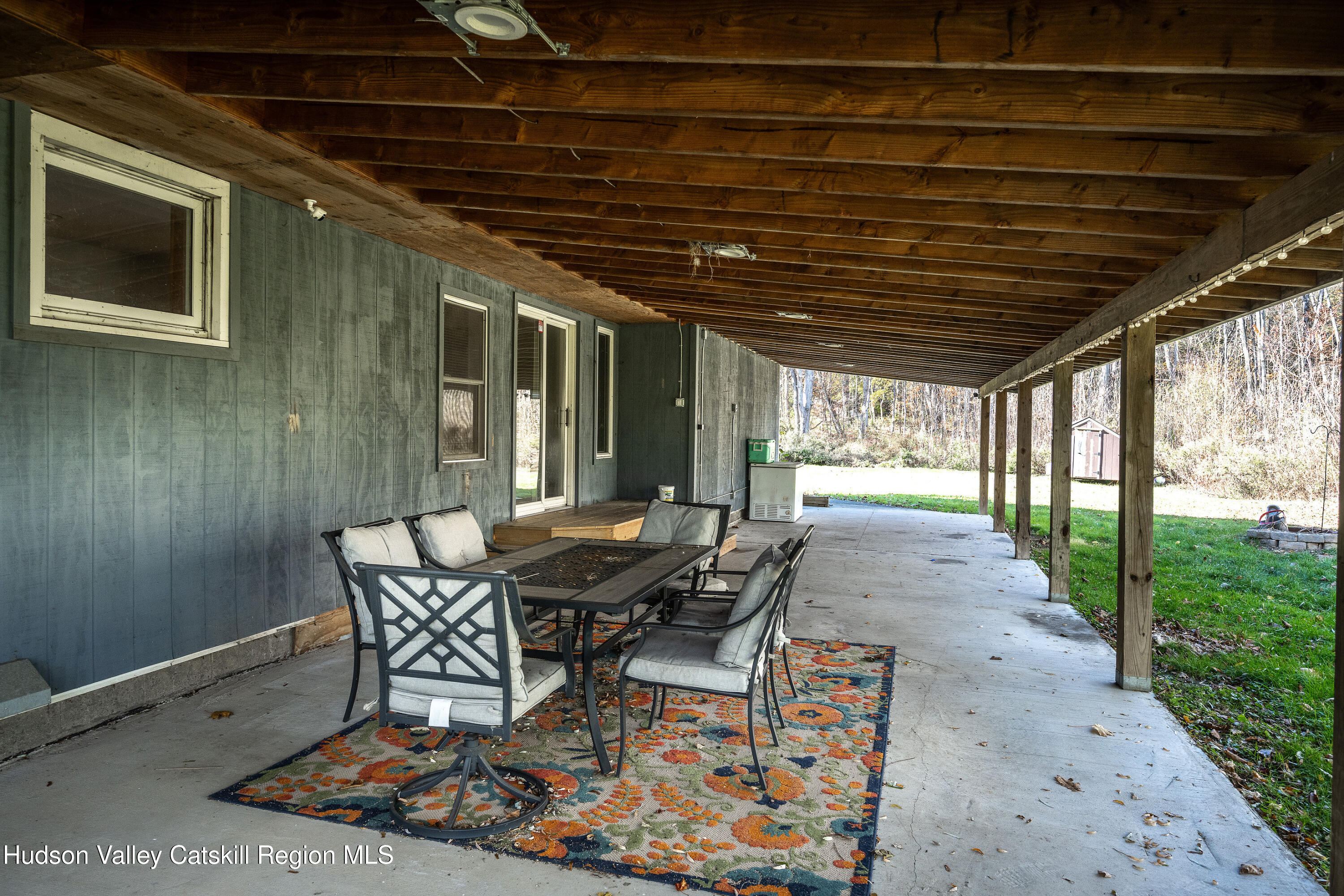 3024 Highway 213 Stone Ridge, NY 12484 - Photo 16 of 31 a patio with glass top table and chairs