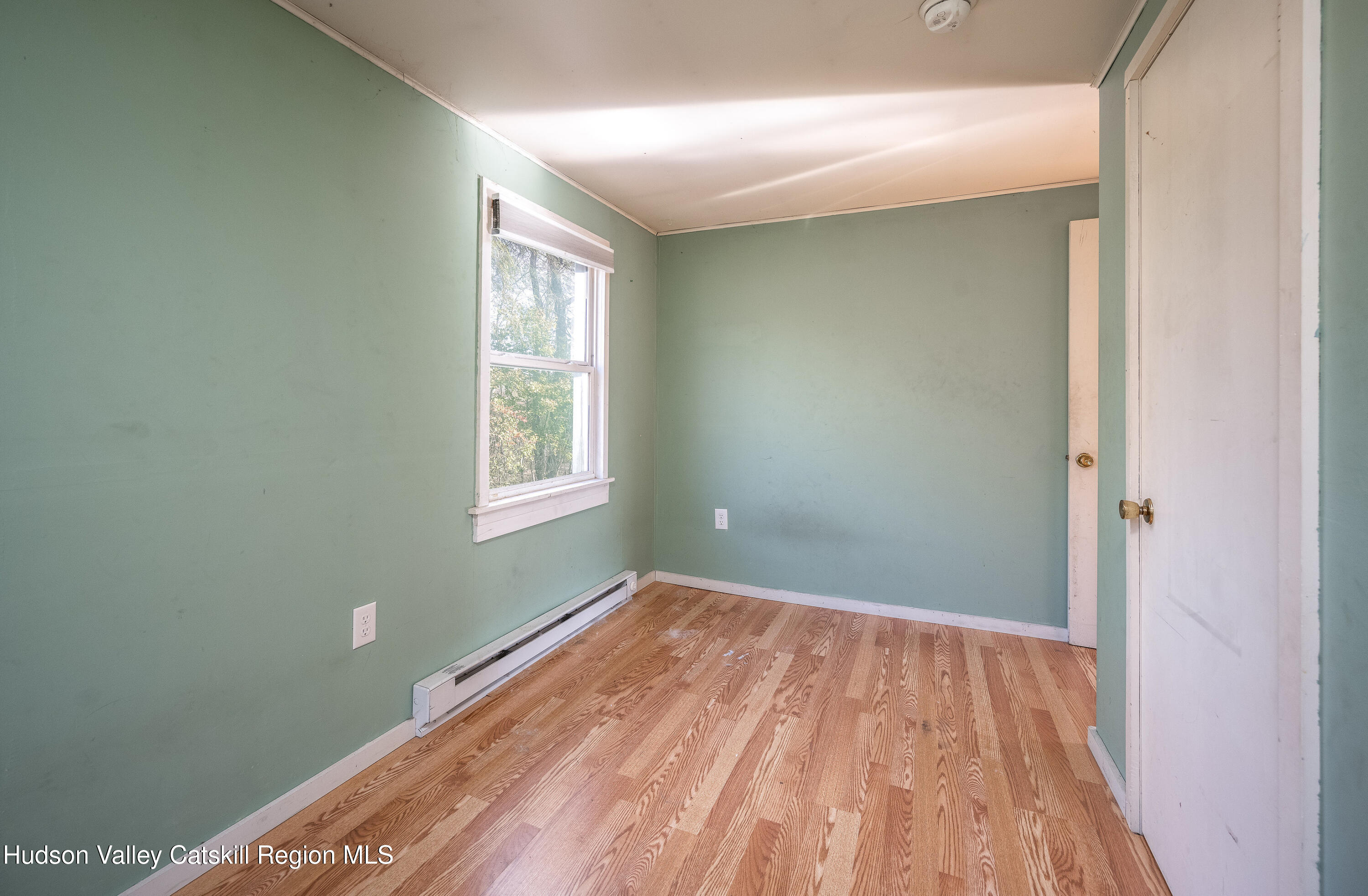 3024 Highway 213 Stone Ridge, NY 12484 - Photo 27 of 31 a view of a room with wooden floor and fan