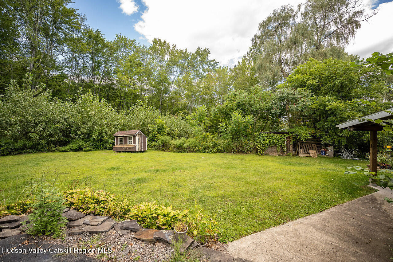 3024 Highway 213 Stone Ridge, NY 12484 - Photo 29 of 31 a view of a garden with a bench and trees