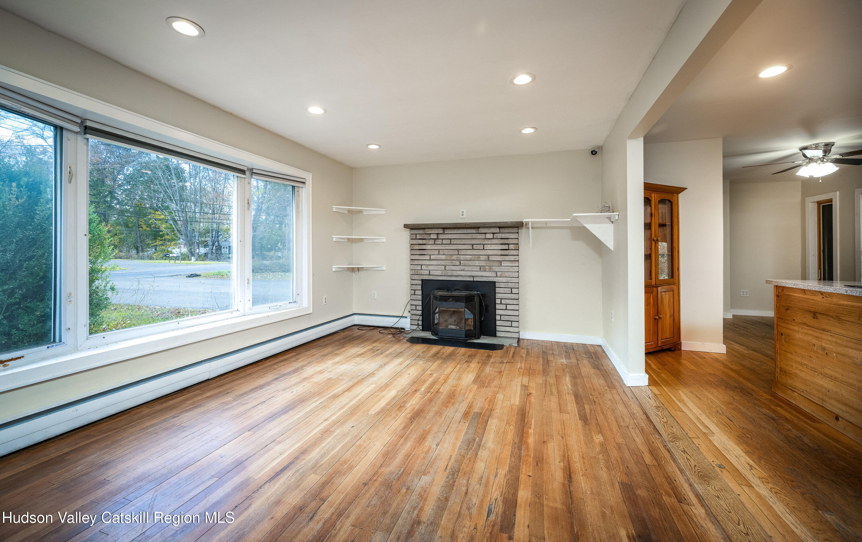 3024 Highway 213 Stone Ridge, NY 12484 - Photo 6 of 31 a view of a livingroom with wooden floor and a fireplace