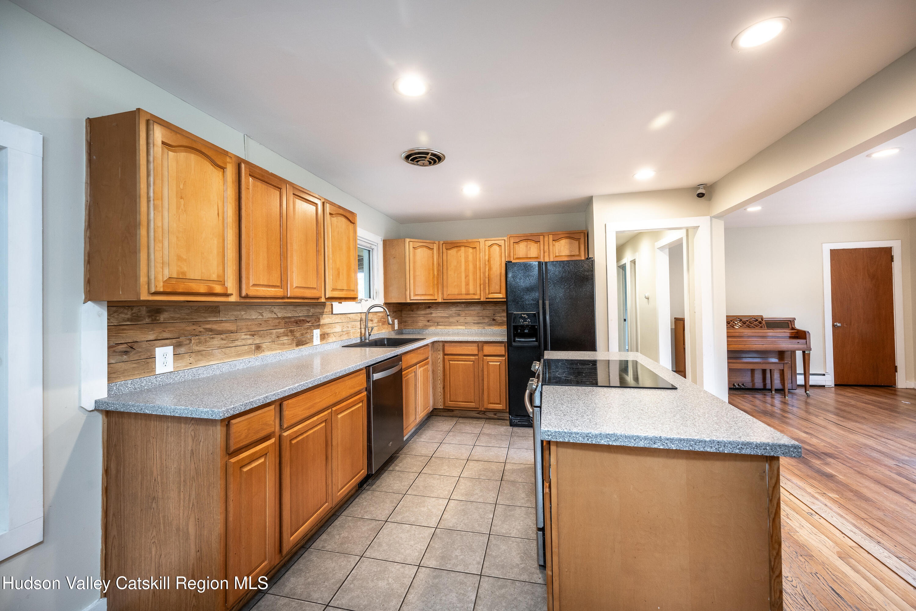 3024 Highway 213 Stone Ridge, NY 12484 - Photo 8 of 31 a large kitchen with stainless steel appliances kitchen island granite countertop a sink and cabinets
