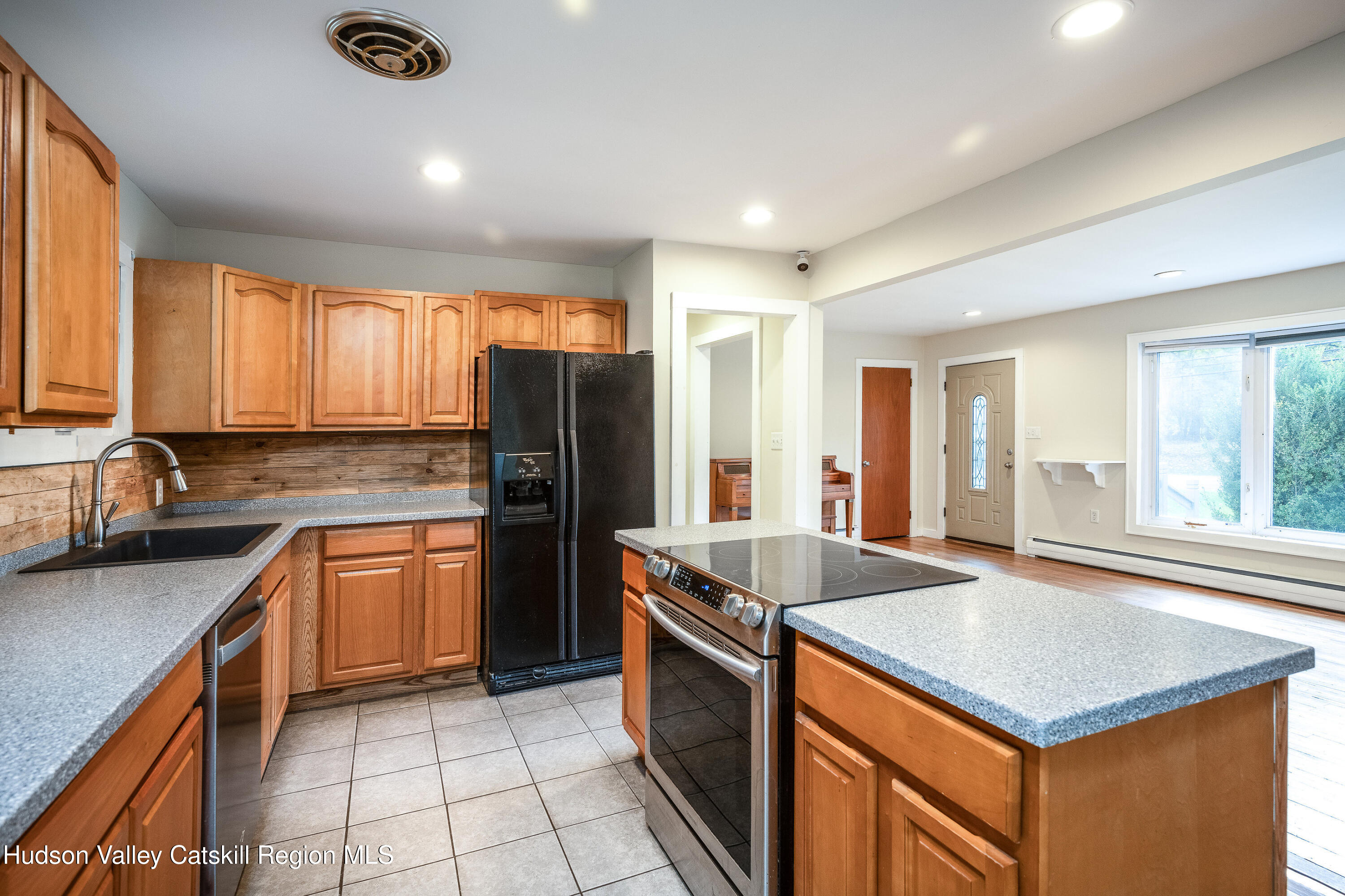 3024 Highway 213 Stone Ridge, NY 12484 - Photo 10 of 31 a kitchen with stainless steel appliances granite countertop a sink stove and refrigerator
