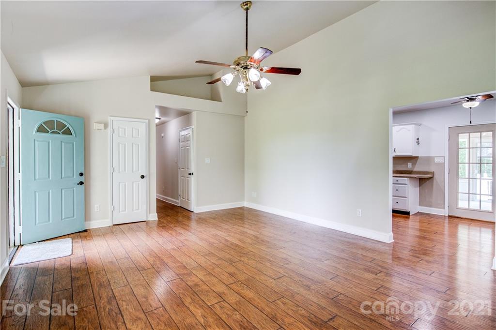 4004 Belk Mill Road Wingate, NC 28174 - Photo 11 of 44 a view of a livingroom with wooden floor and a ceiling fan
