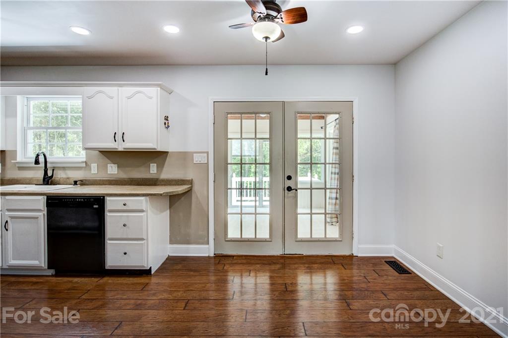 4004 Belk Mill Road Wingate, NC 28174 - Photo 14 of 44 a kitchen with granite countertop a stove a sink and a granite counter tops with wooden floors