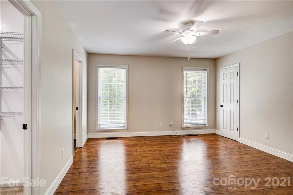 4004 Belk Mill Road Wingate, NC 28174 - Photo 17 of 44 wooden floor in an empty room with a window
