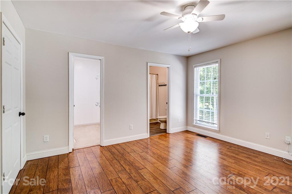 4004 Belk Mill Road Wingate, NC 28174 - Photo 18 of 44 wooden floor in an empty room with a window