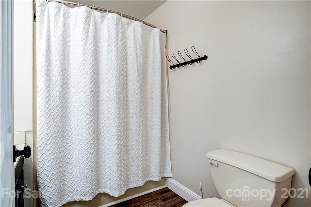 4004 Belk Mill Road Wingate, NC 28174 - Photo 19 of 44 a bathroom with a shower curtain and sink