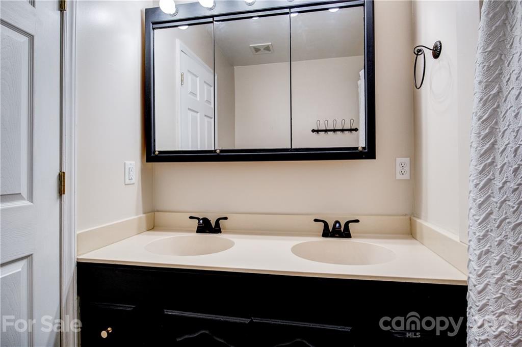 4004 Belk Mill Road Wingate, NC 28174 - Photo 20 of 44 a bathroom with a sink and a mirror