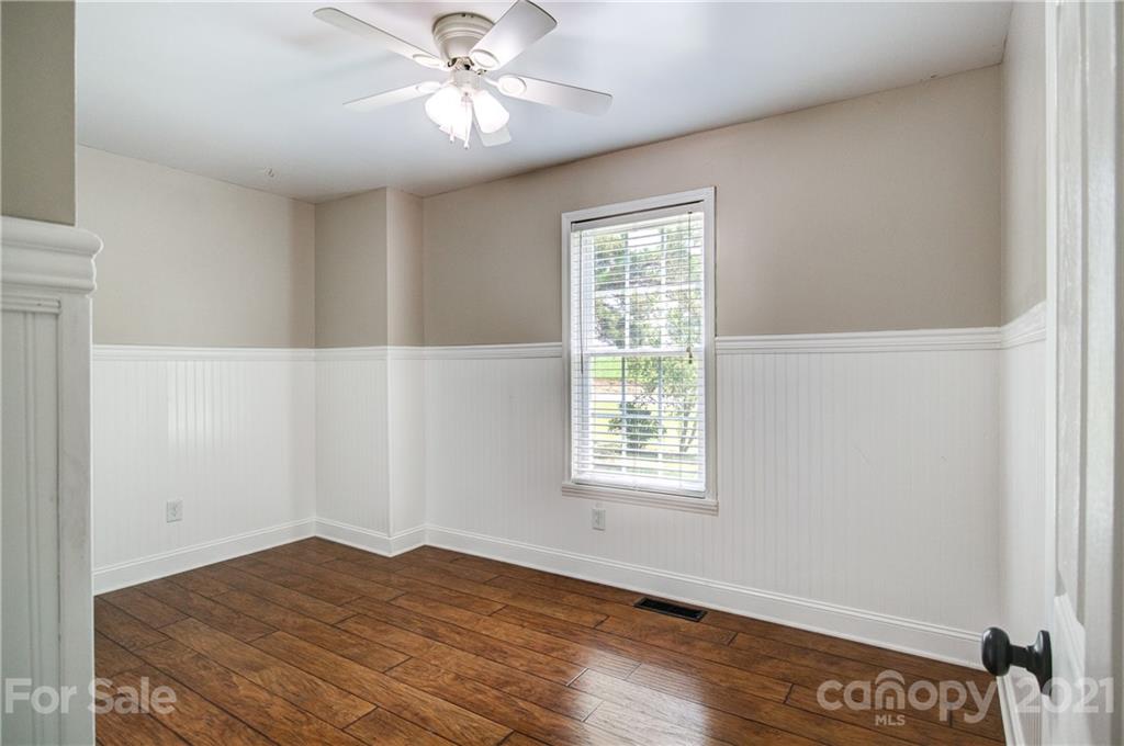4004 Belk Mill Road Wingate, NC 28174 - Photo 21 of 44 a view of empty room with wooden floor and fan