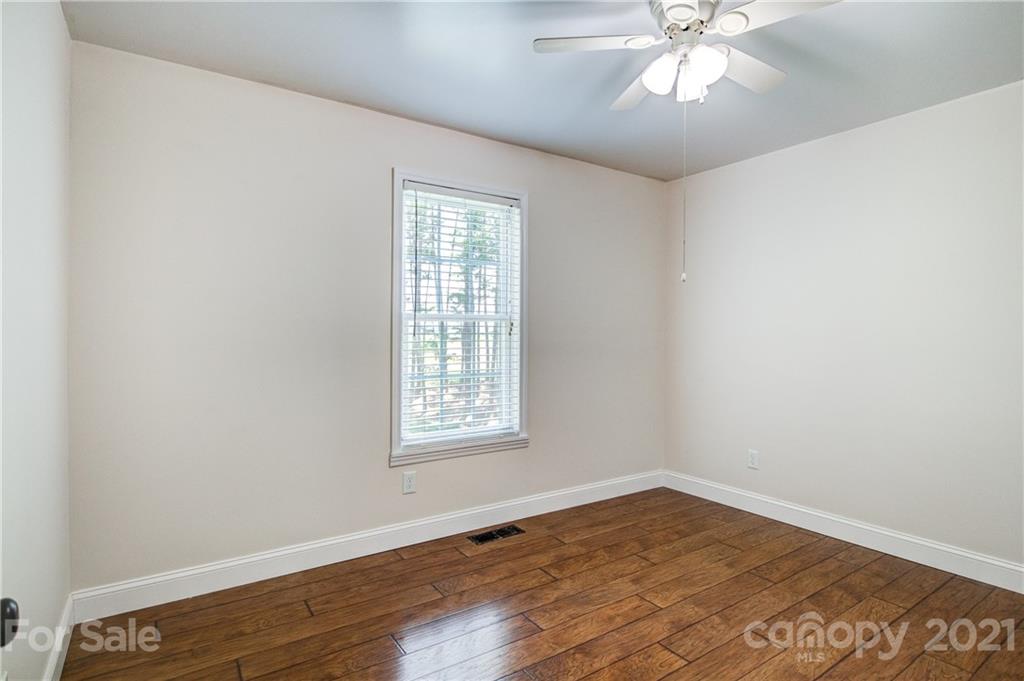 4004 Belk Mill Road Wingate, NC 28174 - Photo 22 of 44 an empty room with wooden floor closet and windows