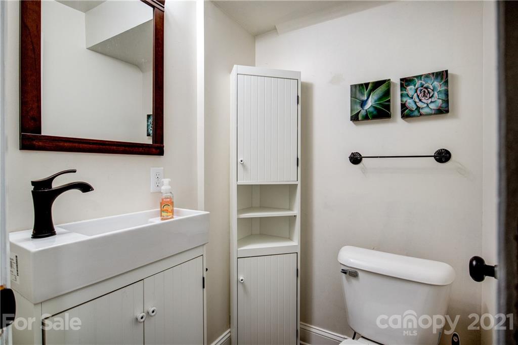 4004 Belk Mill Road Wingate, NC 28174 - Photo 26 of 44 a bathroom with a toilet sink and mirror