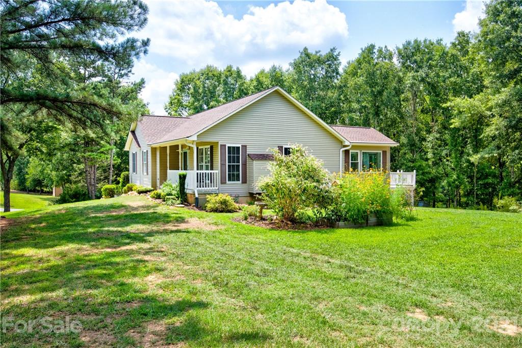 4004 Belk Mill Road Wingate, NC 28174 - Photo 30 of 44 a view of a house with a big yard potted plants and large tree