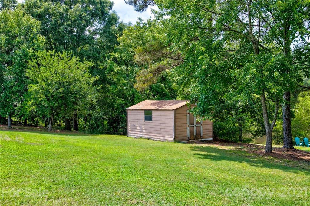 4004 Belk Mill Road Wingate, NC 28174 - Photo 33 of 44 a front view of a house with a garden and yard