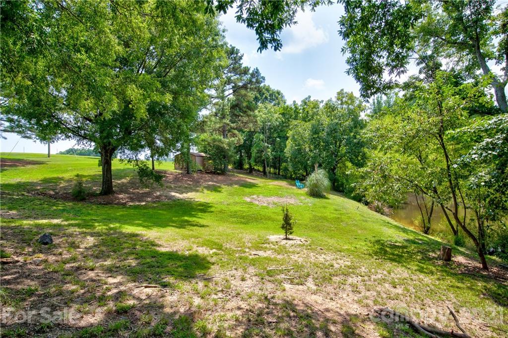 4004 Belk Mill Road Wingate, NC 28174 - Photo 35 of 44 a view of a backyard with large trees