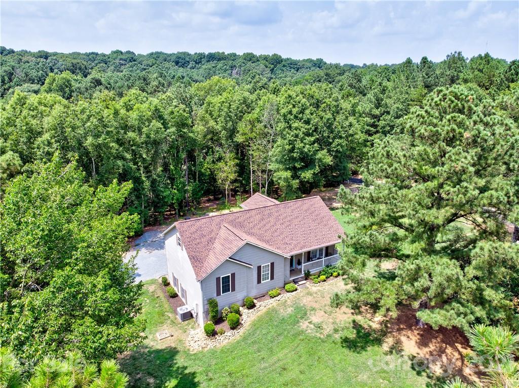 4004 Belk Mill Road Wingate, NC 28174 - Photo 36 of 44 an aerial view of a house with yard and outdoor seating