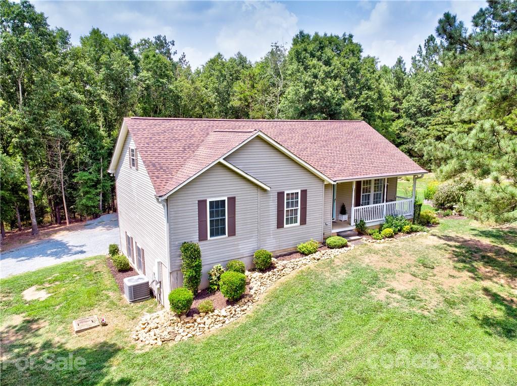 4004 Belk Mill Road Wingate, NC 28174 - Photo 41 of 44 a view of a house with a yard and sitting area