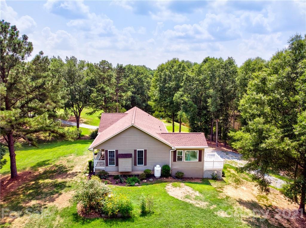4004 Belk Mill Road Wingate, NC 28174 - Photo 42 of 44 a view of a house with a yard and a garden
