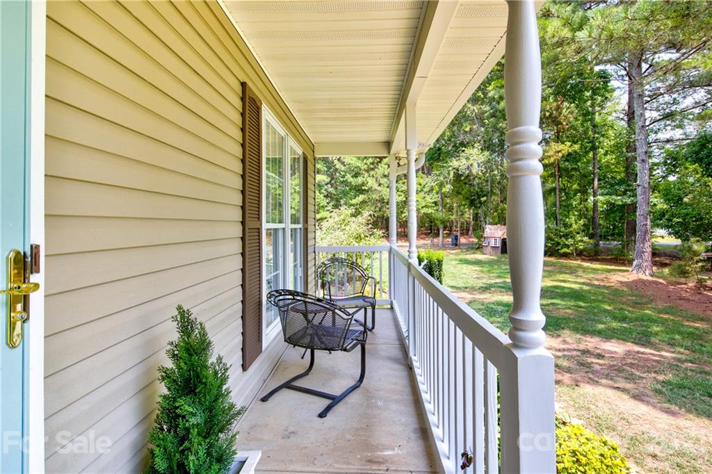 4004 Belk Mill Road Wingate, NC 28174 - Photo 6 of 44 a view of a balcony with furniture and garden
