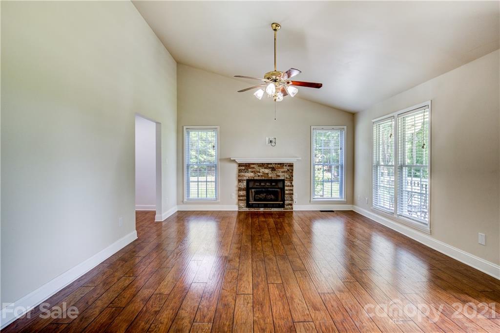4004 Belk Mill Road Wingate, NC 28174 - Photo 8 of 44 wooden floor in an empty room with a window