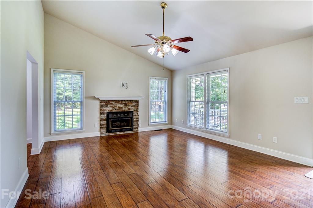 4004 Belk Mill Road Wingate, NC 28174 - Photo 9 of 44 a view of a room with wooden floor fireplace and a window