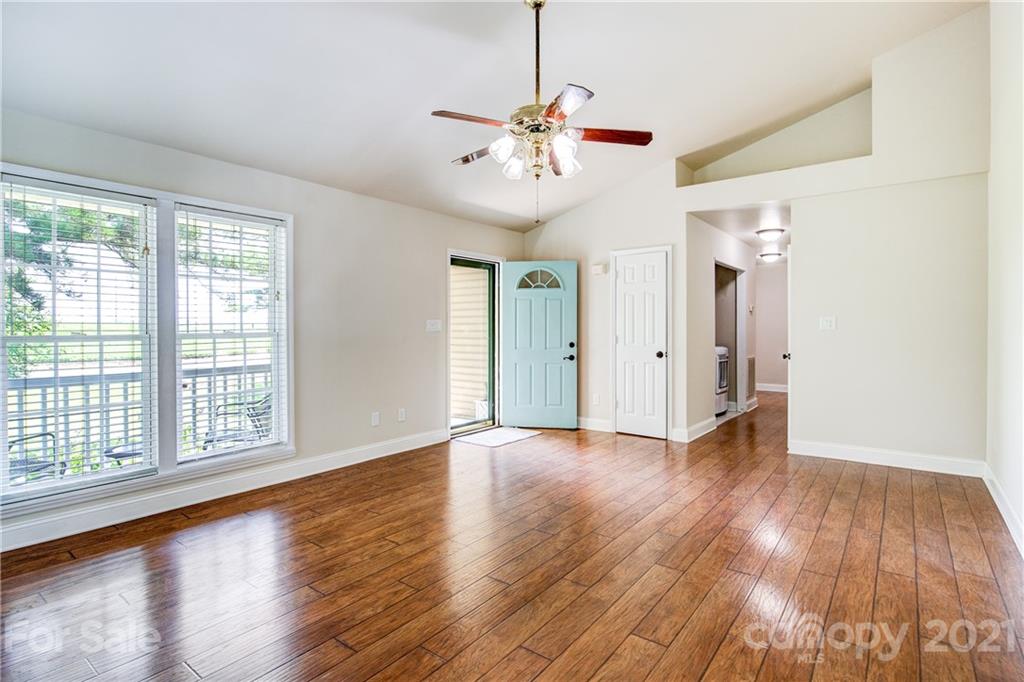 4004 Belk Mill Road Wingate, NC 28174 - Photo 10 of 44 a view of an empty room with wooden floor and a window