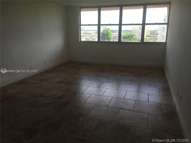 an empty room with a empty space and window