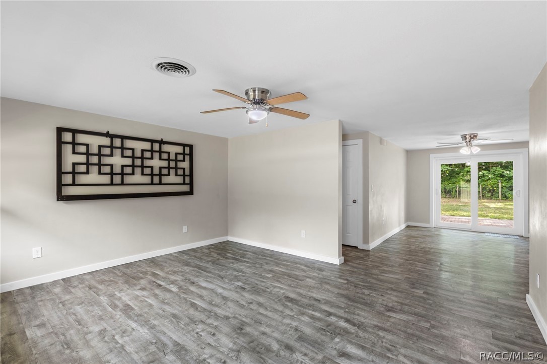 107 Allen Avenue Inglis, FL 34449 - Photo 7 of 36 wooden floor in an empty room with a window