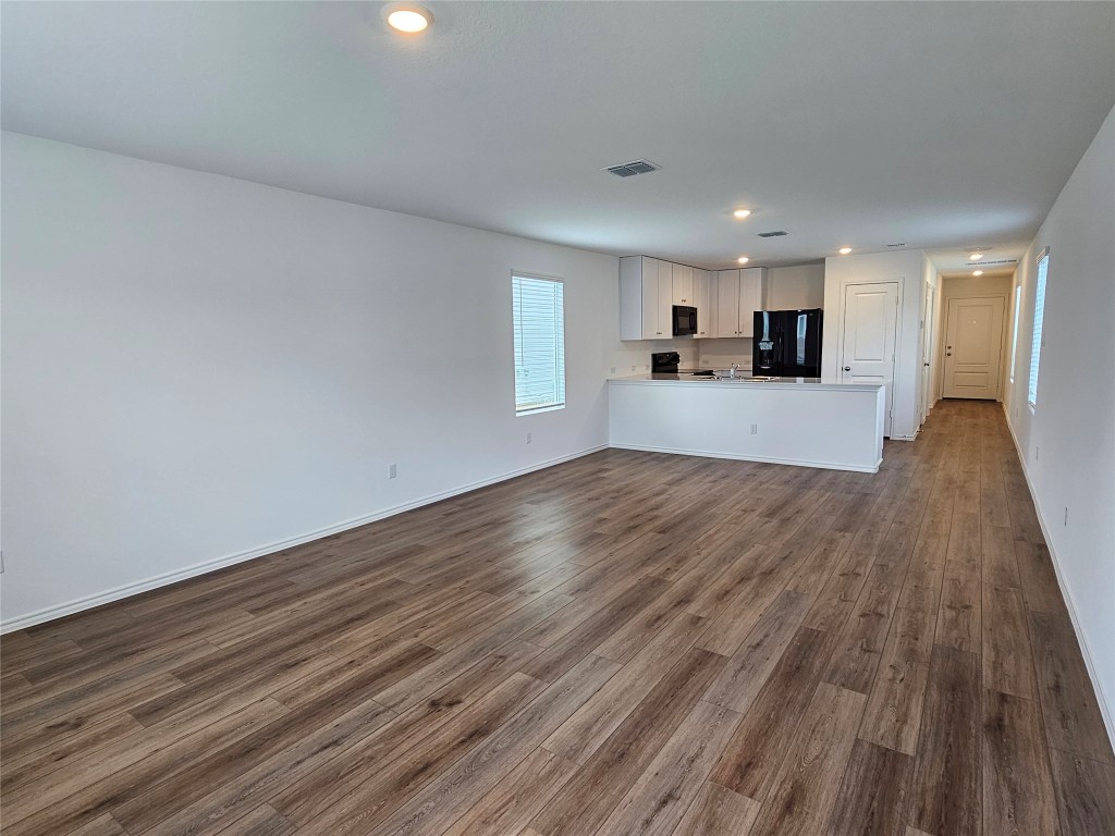 704 Commander Abbott Drive Jarrell, TX 76537 - Photo 12 of 29 a view of a kitchen with cabinets and wooden floor