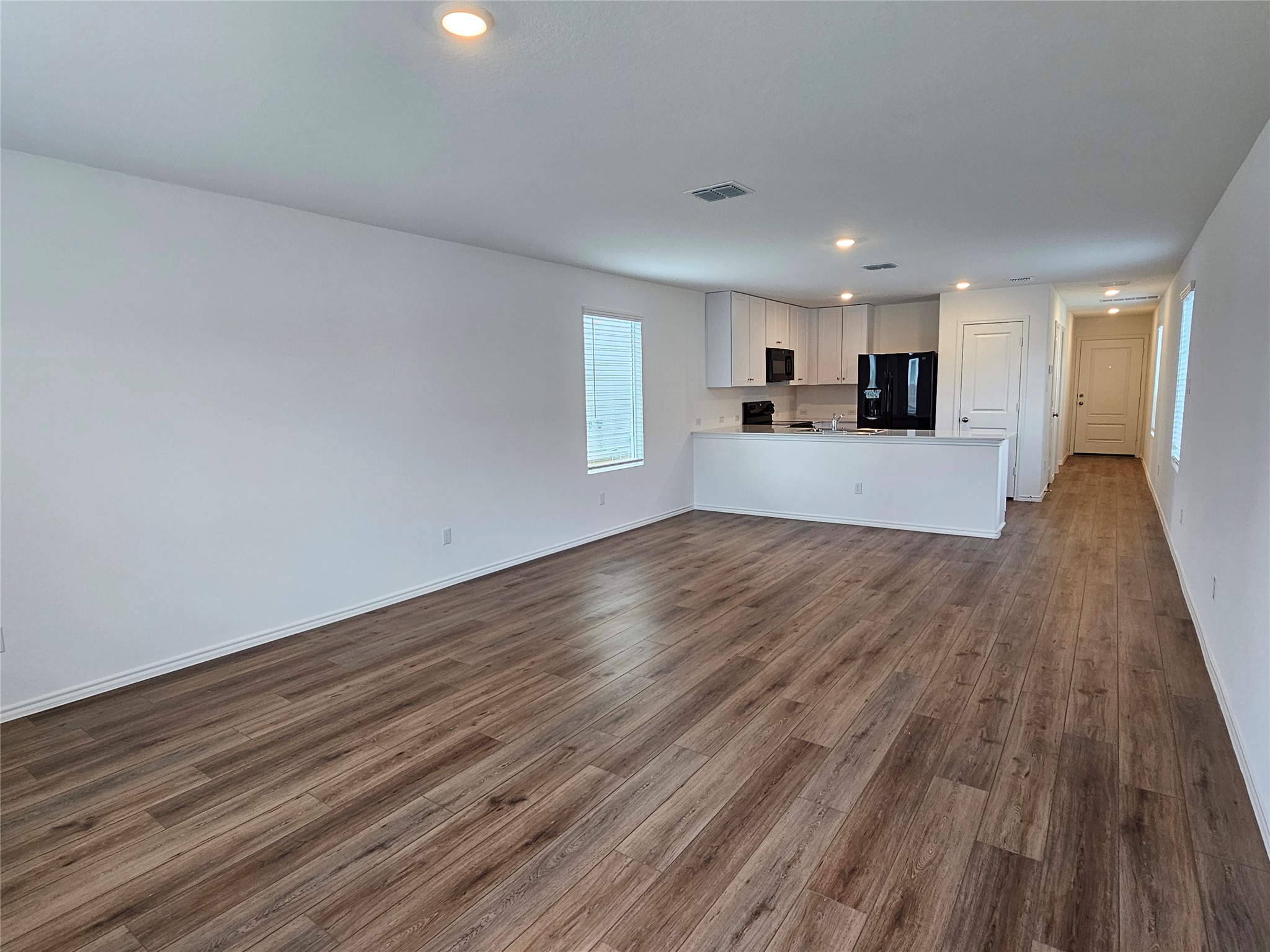 704 Commander Abbott Drive Jarrell, TX 76537 - Photo 12 of 29 a view of a kitchen with cabinets and wooden floor