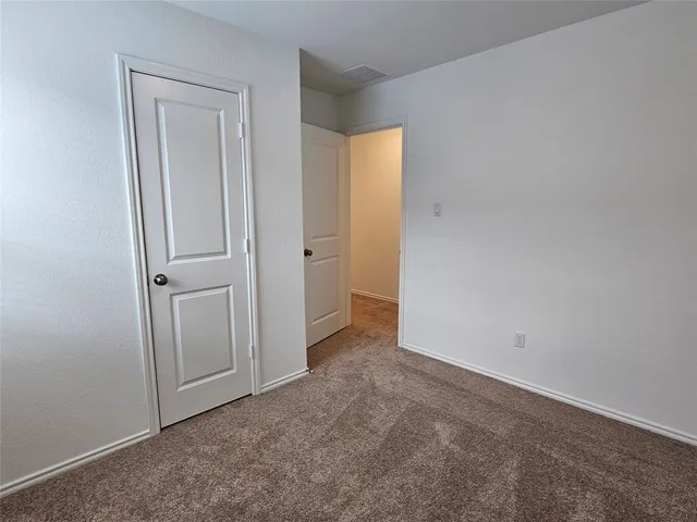 an empty room with closet area