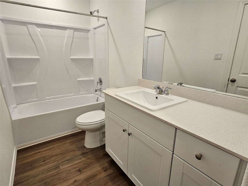 704 Commander Abbott Drive Jarrell, TX 76537 - Photo 19 of 29 a bathroom with a sink a toilet and a bathtub