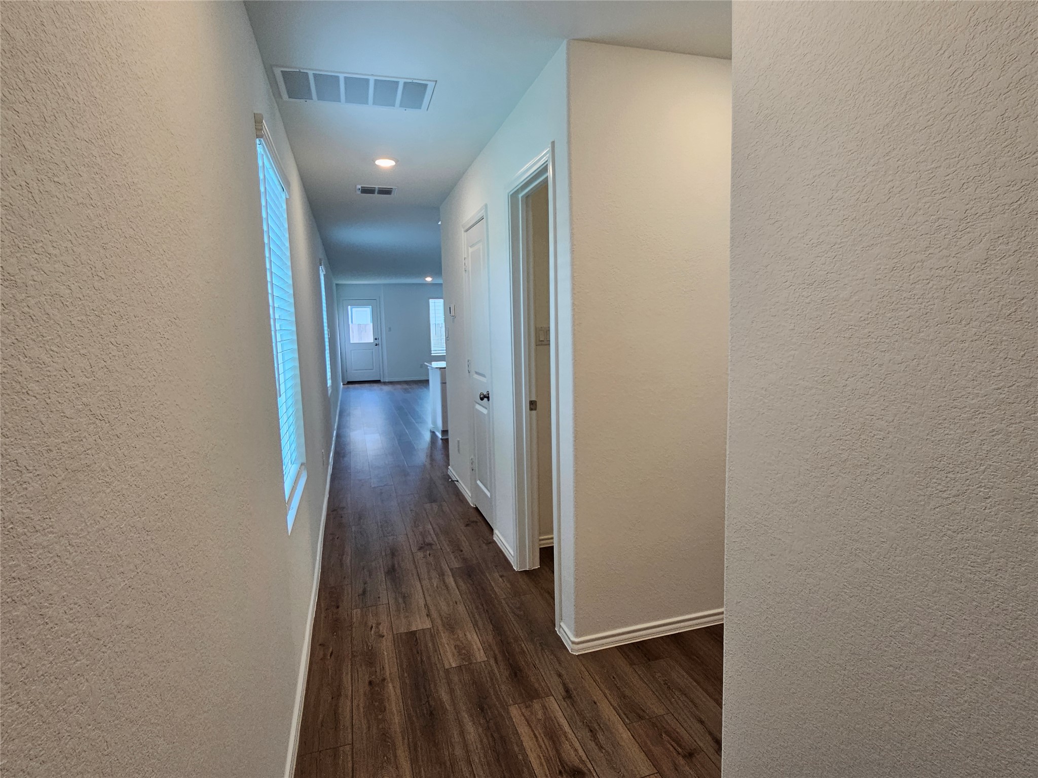 704 Commander Abbott Drive Jarrell, TX 76537 - Photo 4 of 29 a view of a hallway with wooden floor