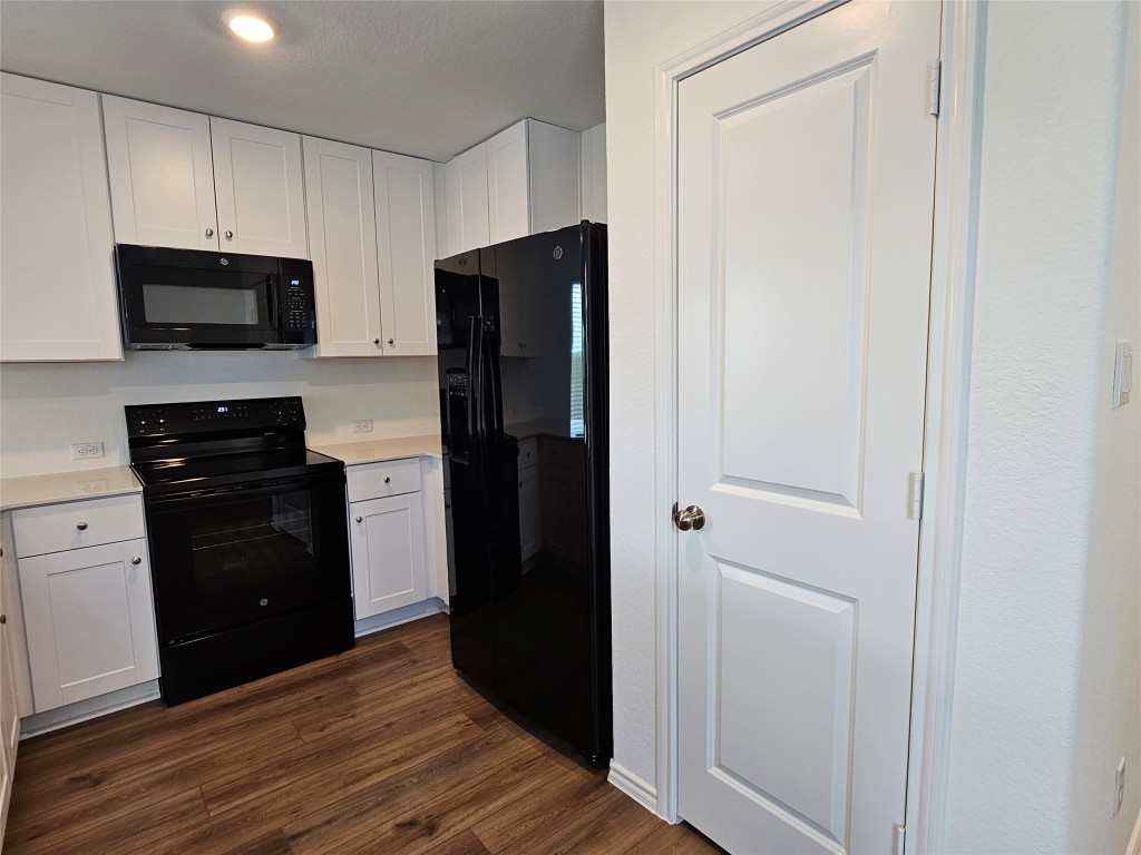 704 Commander Abbott Drive Jarrell, TX 76537 - Photo 9 of 29 a kitchen with stainless steel appliances granite countertop a refrigerator and a stove